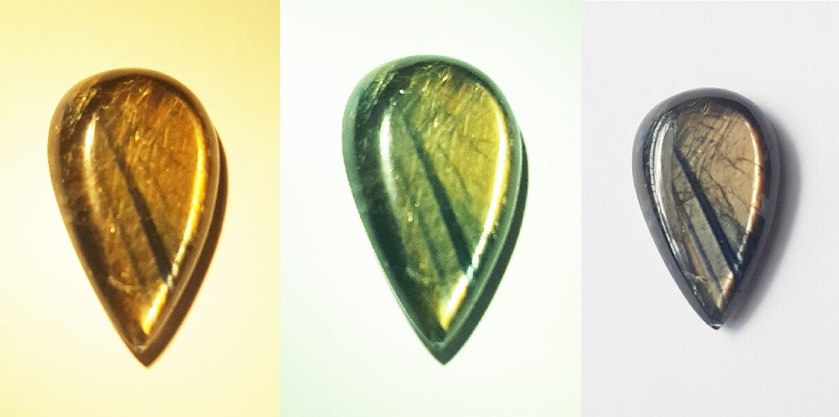 The same pear-shaped gold sheen sapphire cabochon shown three times, looking golden, green-gold and grey-brown under different lighting.
